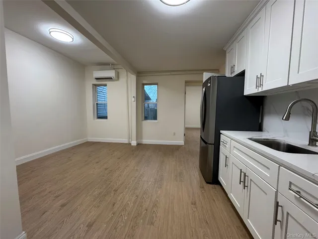 a kitchen with a refrigerator and cabinets