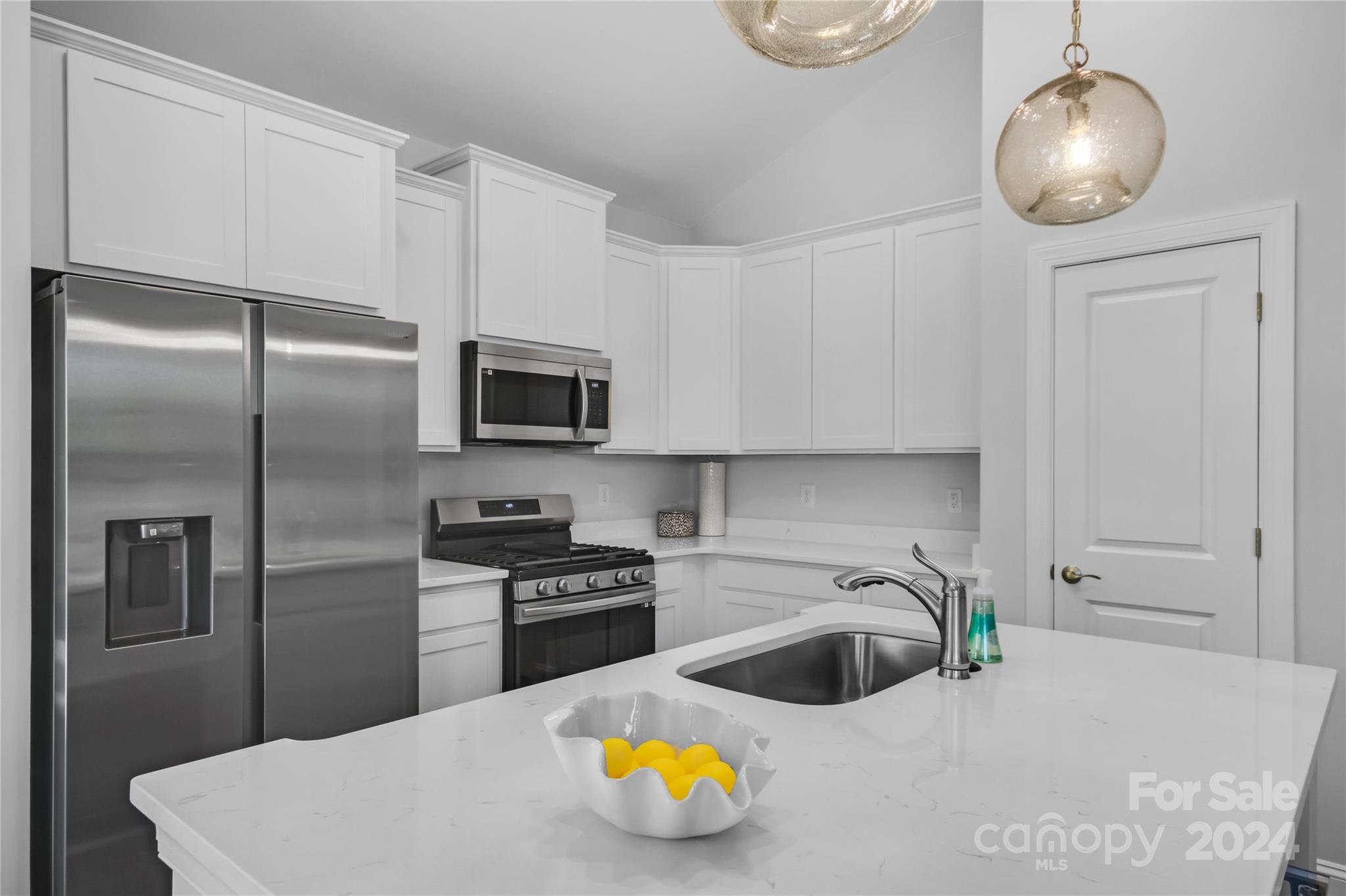 3159 Laurel Brook Drive Denver, NC 28037 - Photo 3 of 30 a kitchen with stainless steel appliances granite countertop a sink a stove and a refrigerator