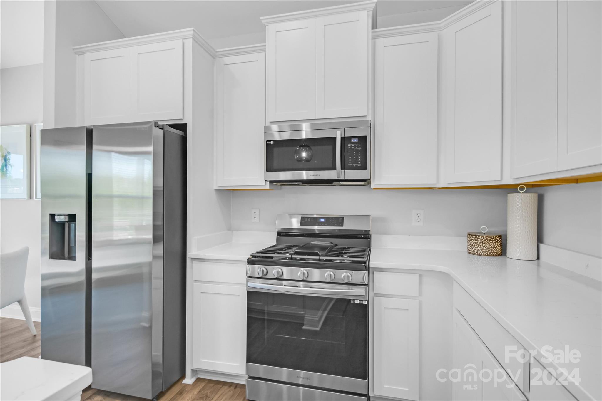 3159 Laurel Brook Drive Denver, NC 28037 - Photo 4 of 30 a kitchen with stainless steel appliances granite countertop a stove a refrigerator and a microwave