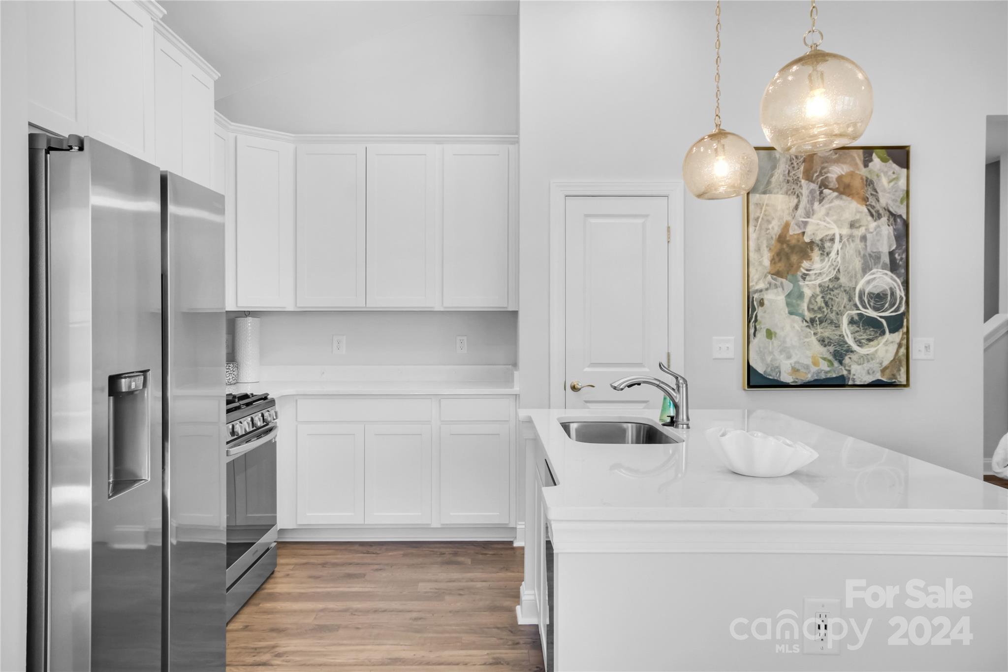 3159 Laurel Brook Drive Denver, NC 28037 - Photo 6 of 30 a kitchen with stainless steel appliances a refrigerator sink and cabinets
