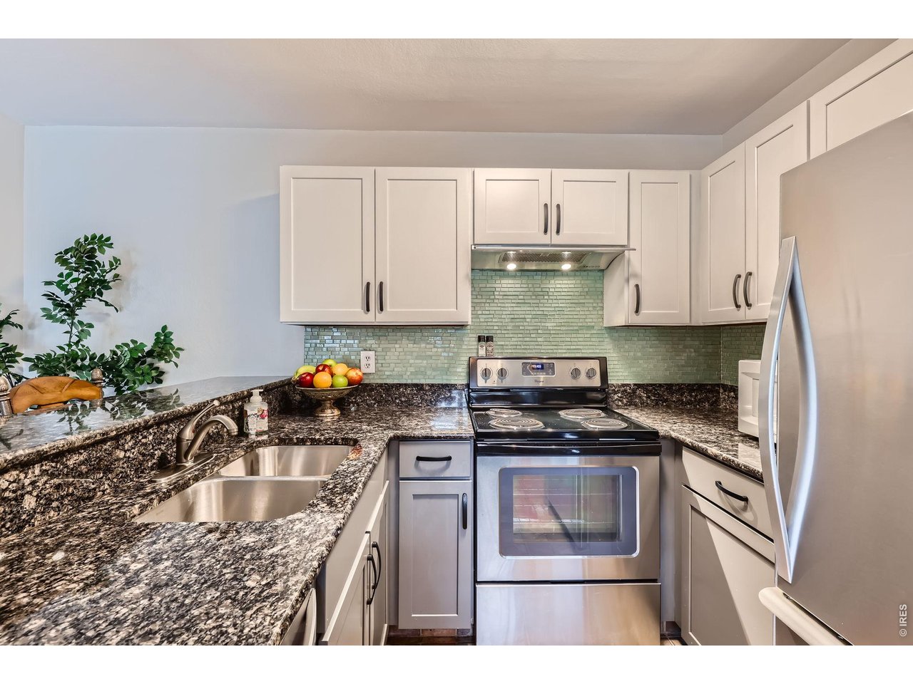 3515 28th Street, Unit 108 Boulder, CO 80301 - Photo 7 of 29 Stylish Tuxedo Kitchen with newer stainless appliances, counters, cabinets and backsplash