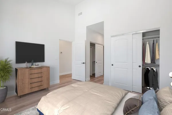 a bedroom with a bed and flat screen tv
