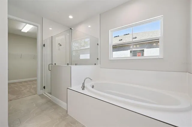 a bathroom with a bathtub and a shower