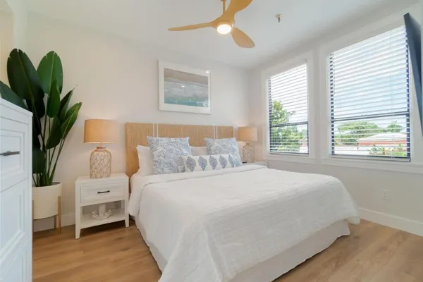 a bedroom with a large bed and a window