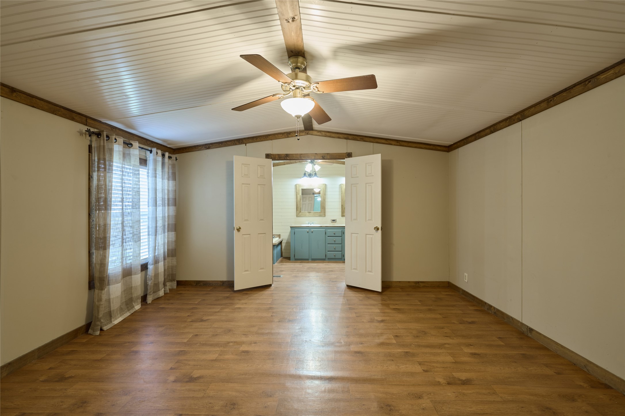 17381 FM 1484 Road Conroe, TX 77303 - Photo 27 of 37 a view of a livingroom with wooden floor and a ceiling fan