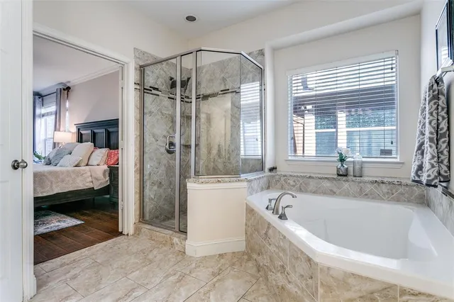 a bathroom with a tub a sink and mirror