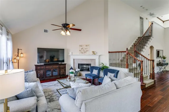 a living room with furniture a fireplace and a flat screen tv