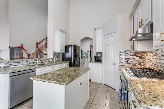 a kitchen with stainless steel appliances granite countertop a stove and a sink