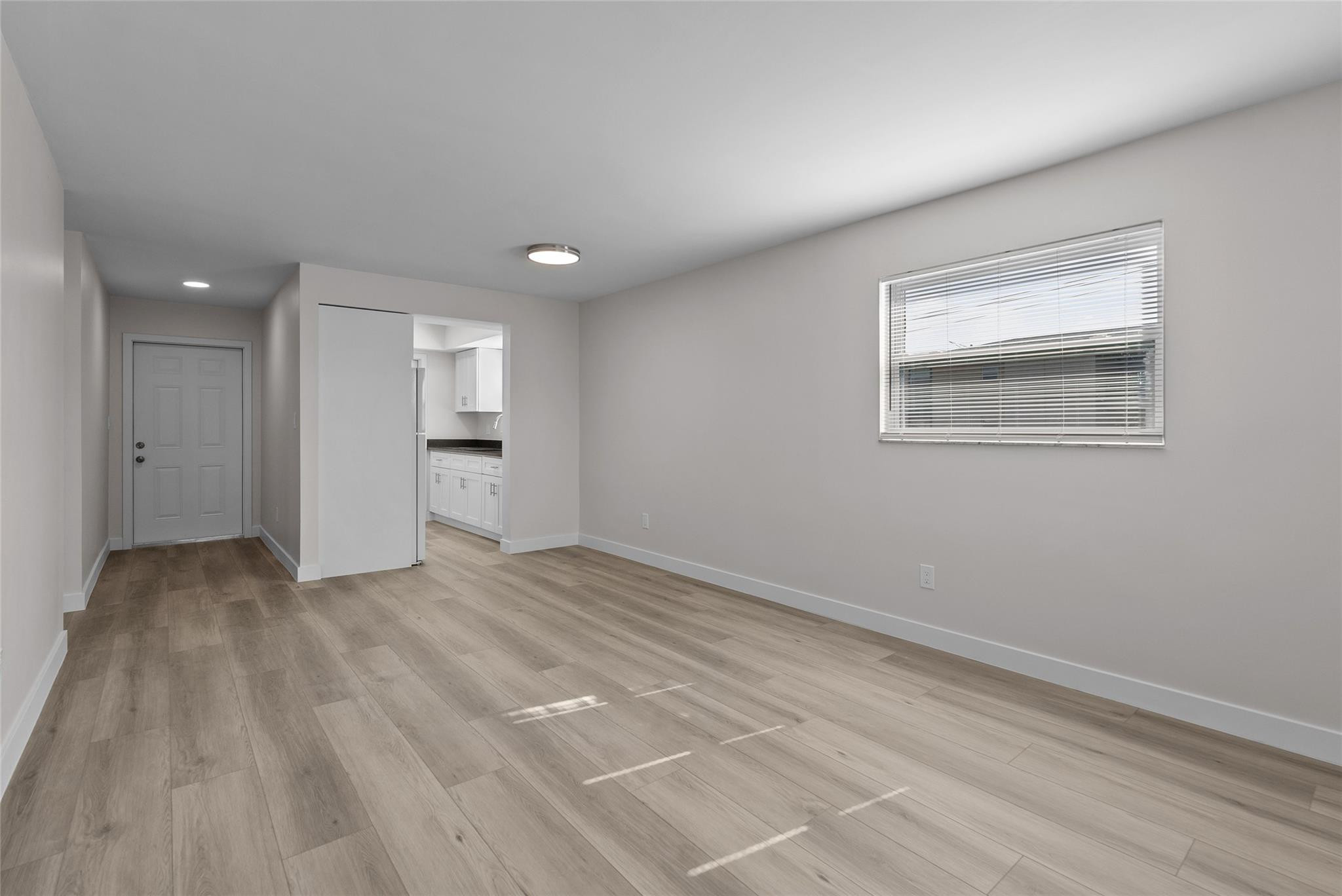 1150 East Sample Road, Unit 202 Pompano Beach, FL 33064 - Photo 9 of 20 a view of an empty room with a window