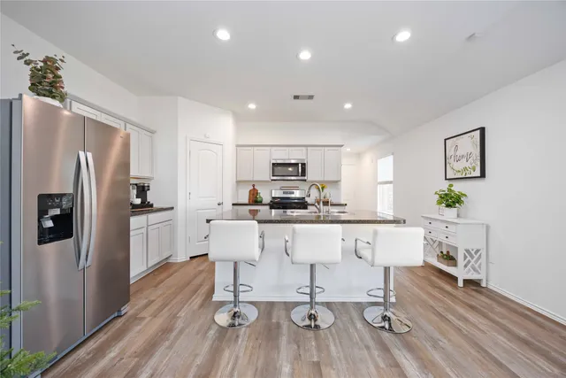 a living room with furniture and a wooden floor