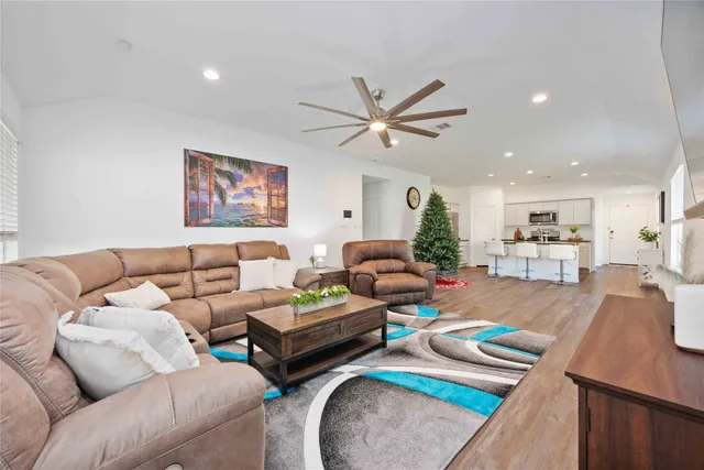 a bedroom with a bed and a flat tv screen on dresser