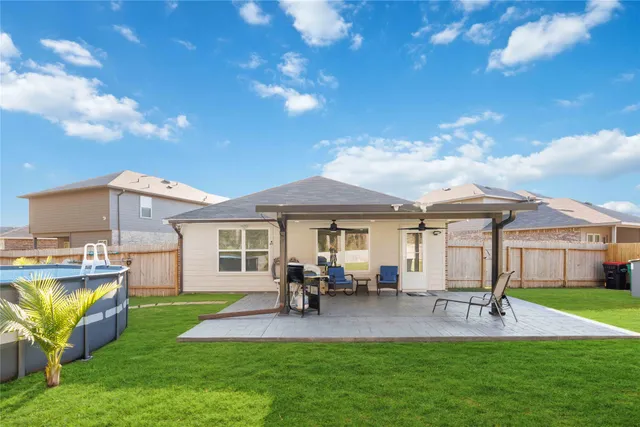 a view of a patio with table and chairs