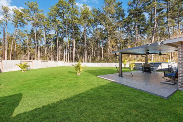 a view of yard with grass and trees