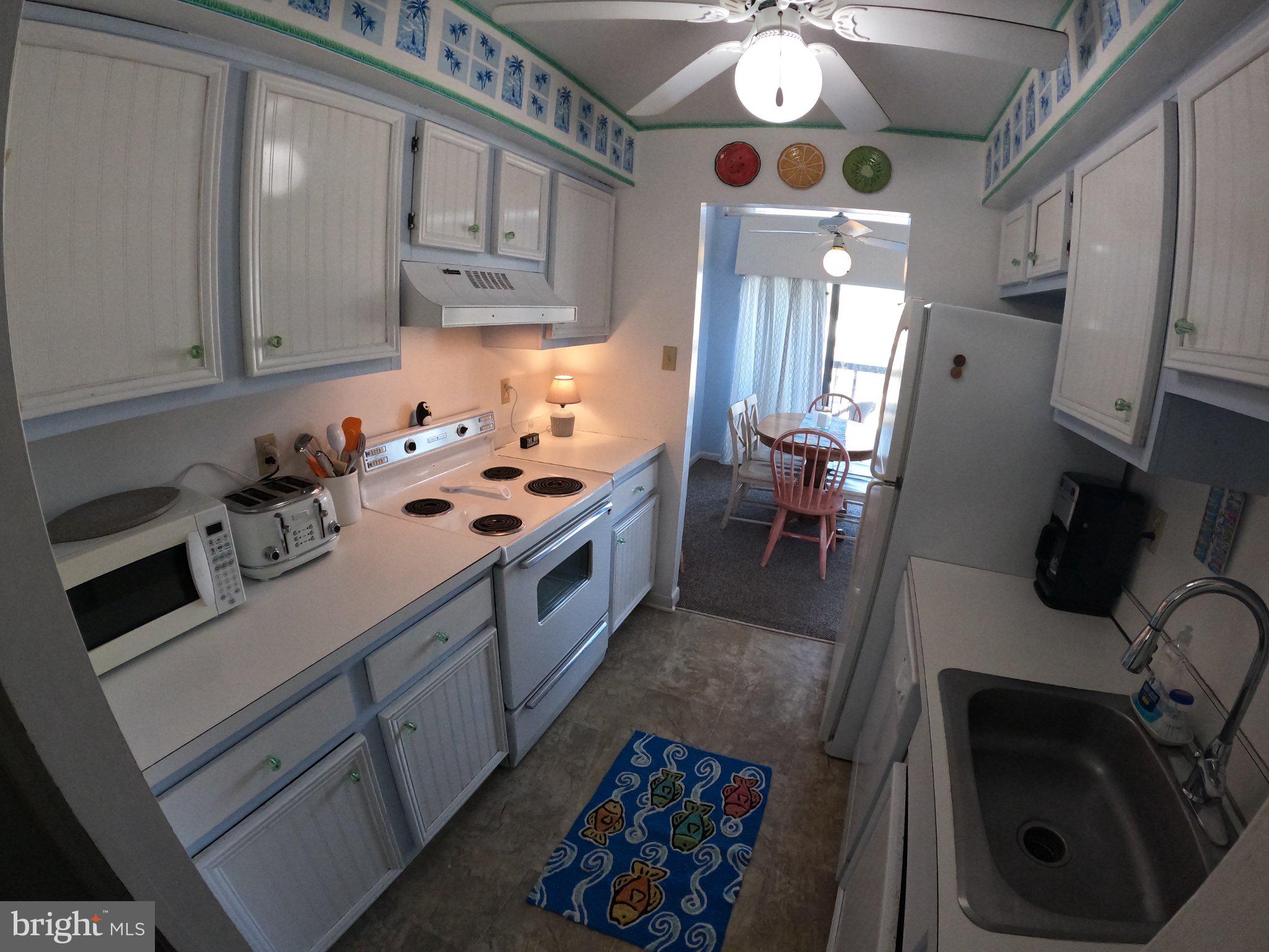 13907 Sand Dune Road, Unit 9A Ocean City, MD 21842 - Photo 11 of 28 Bright and cheerful coastal kitchen.