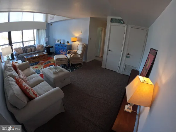 a living room with furniture and a mirror