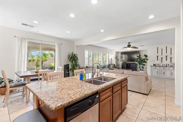 a kitchen with center island table and chairs