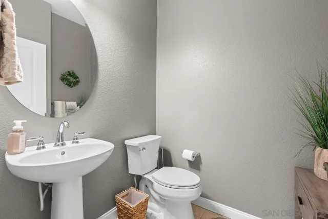 a bathroom with a toilet a sink and a mirror