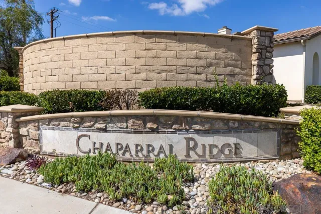 a street sign on a wall next to a road