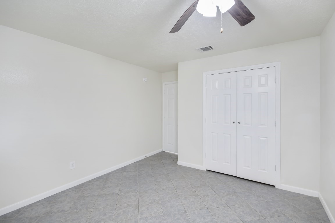 3203 Willie Way Spring, TX 77380 - Photo 18 of 31 an empty room with a ceiling fan and a window