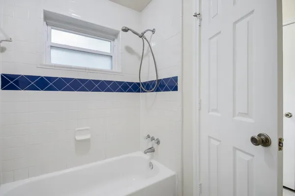 a bathroom with a bathtub and a shower