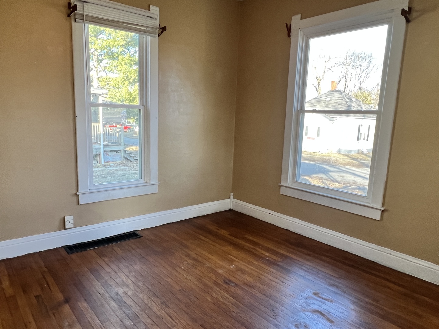 501 North Elm Street Clinton, IL 61727 - Photo 14 of 37 a view of an empty room with wooden floor and a window