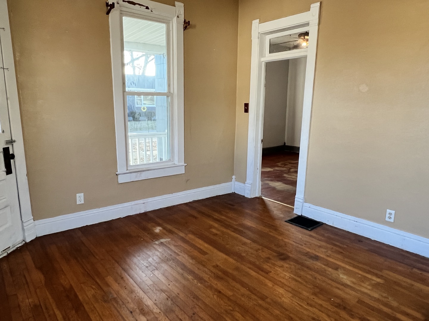 501 North Elm Street Clinton, IL 61727 - Photo 16 of 37 an empty room with wooden floor and windows