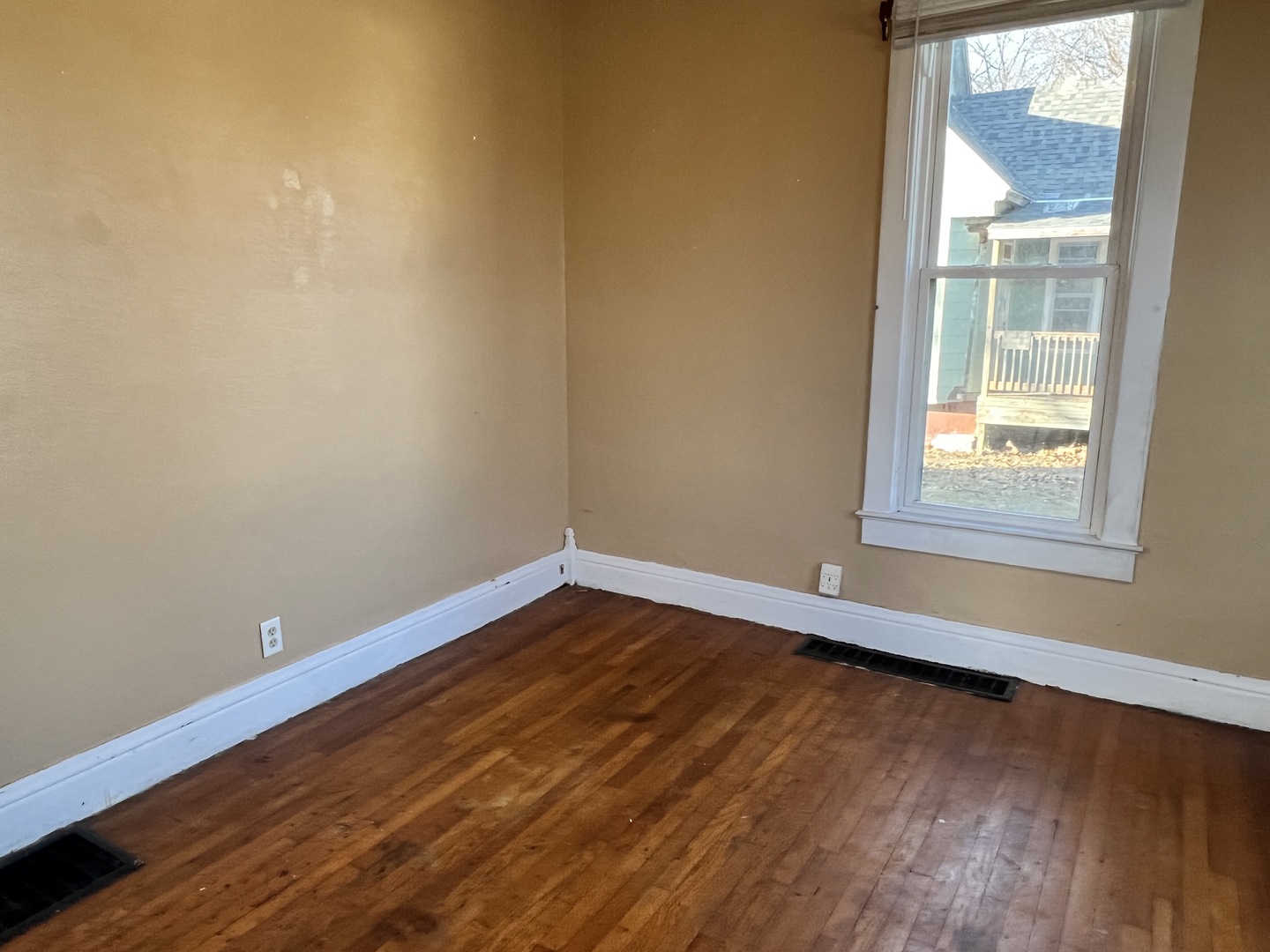 501 North Elm Street Clinton, IL 61727 - Photo 17 of 37 a view of an empty room with wooden floor and a window