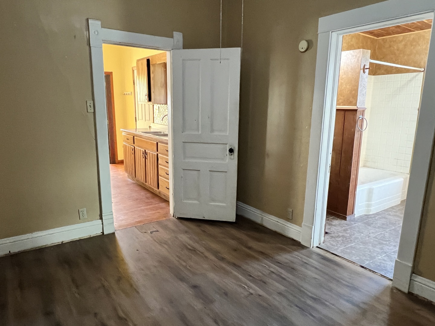501 North Elm Street Clinton, IL 61727 - Photo 19 of 37 an empty room with wooden floor and door