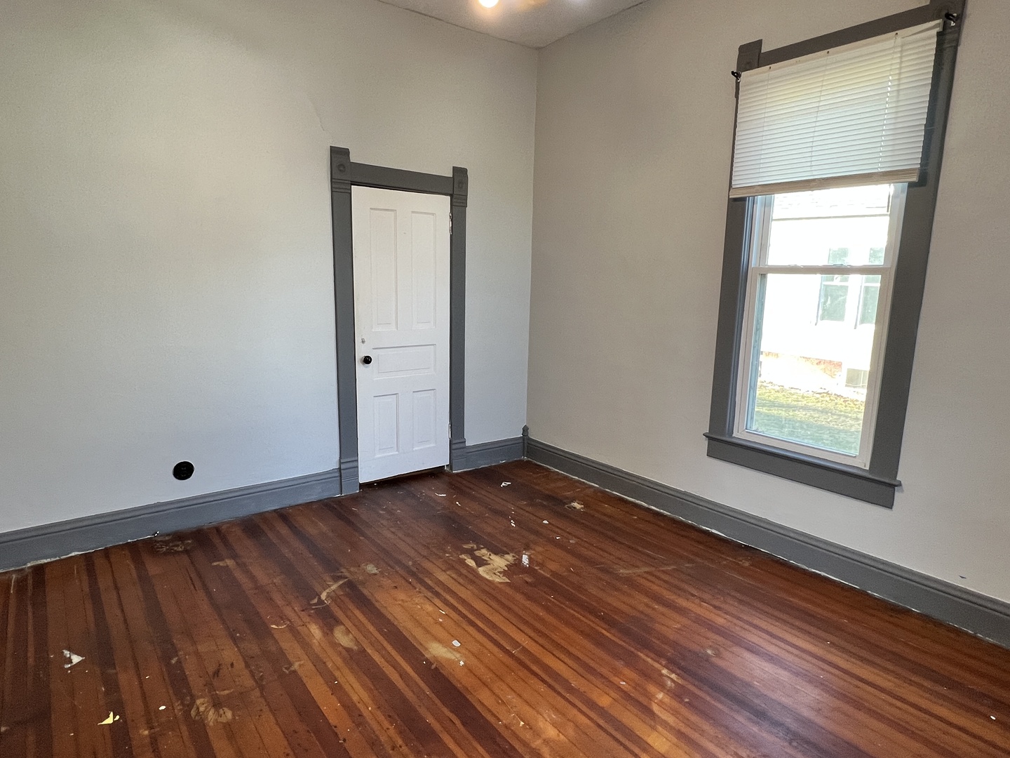 501 North Elm Street Clinton, IL 61727 - Photo 24 of 37 an empty room with wooden floor and windows