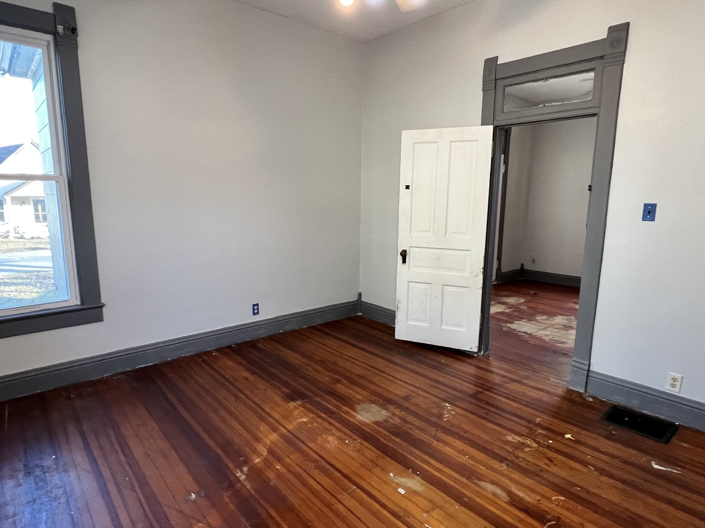 501 North Elm Street Clinton, IL 61727 - Photo 26 of 37 a view of an empty room with wooden floor and a window