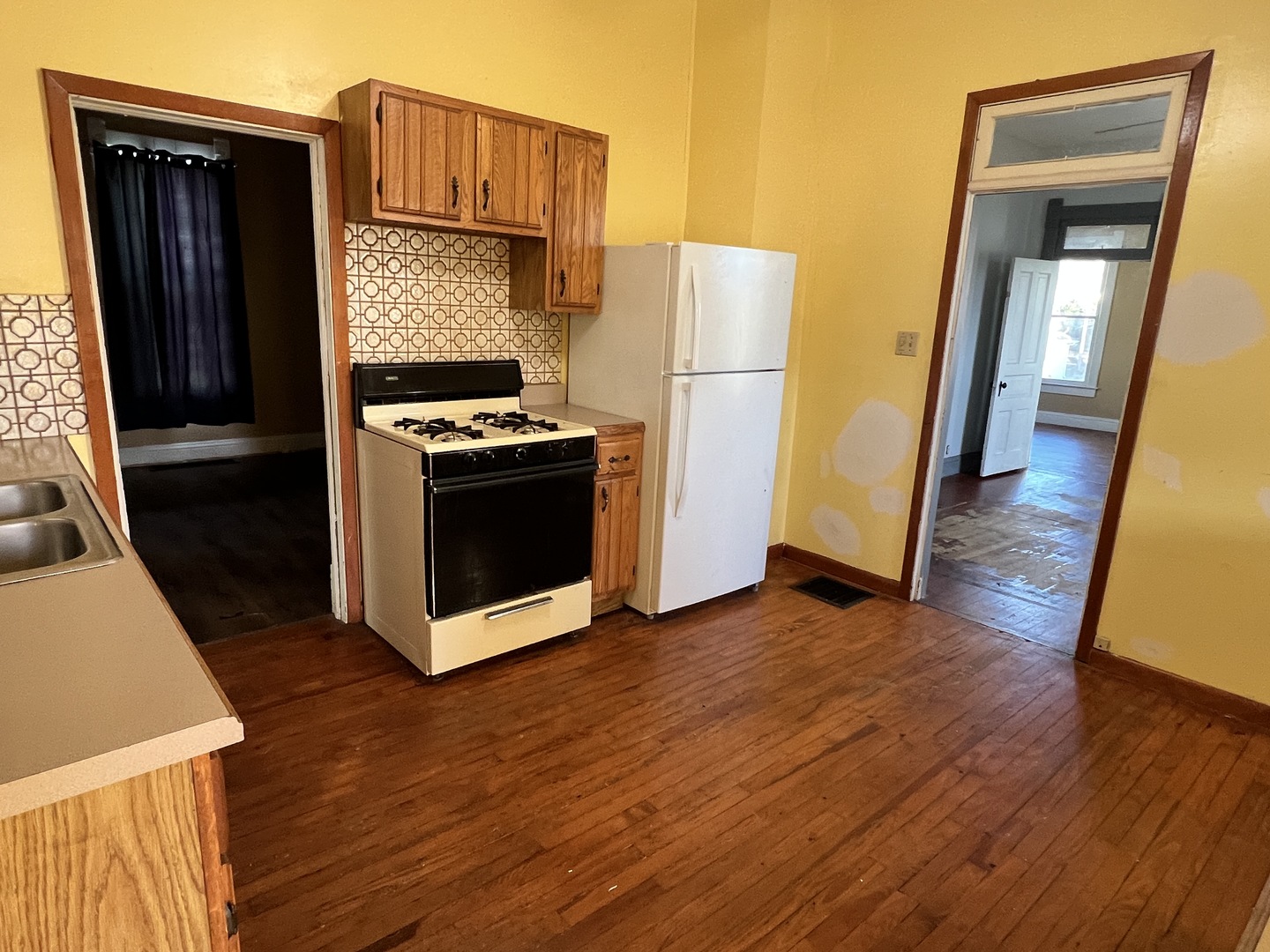 501 North Elm Street Clinton, IL 61727 - Photo 30 of 37 a kitchen with wooden floors and a stove