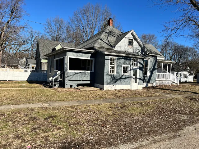 a view of a house with snow on the road