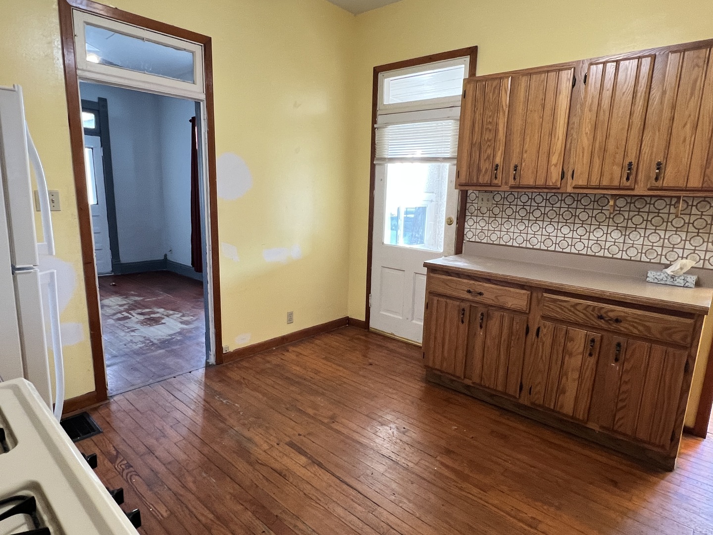 501 North Elm Street Clinton, IL 61727 - Photo 32 of 37 an empty room with wooden floor and cabinet