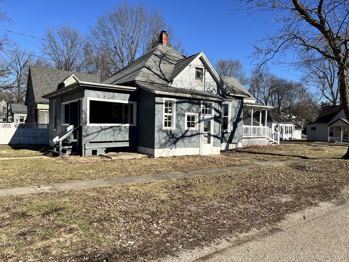 501 North Elm Street Clinton, IL 61727 - Photo 5 of 37 a view of a white house with a snow on the road