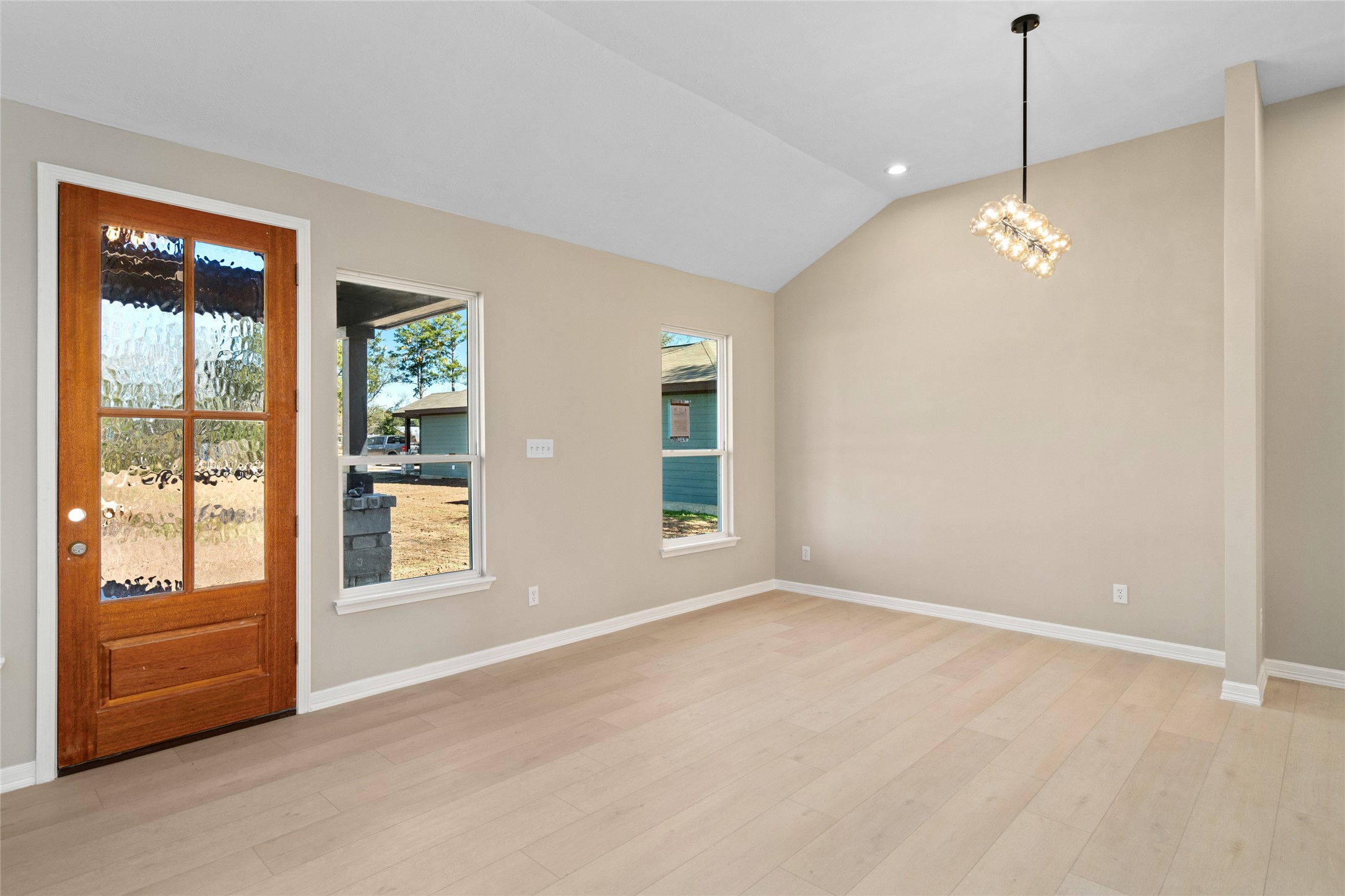 4654 North Teague Street Rosharon, TX 77583 - Photo 24 of 46 Bright and welcoming entry
view featuring a rich wood
front door with glass panels.
Natural light streams through
side windows, highlighting
the airy, modern living room.