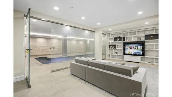 a large white kitchen with a large window and stainless steel appliances