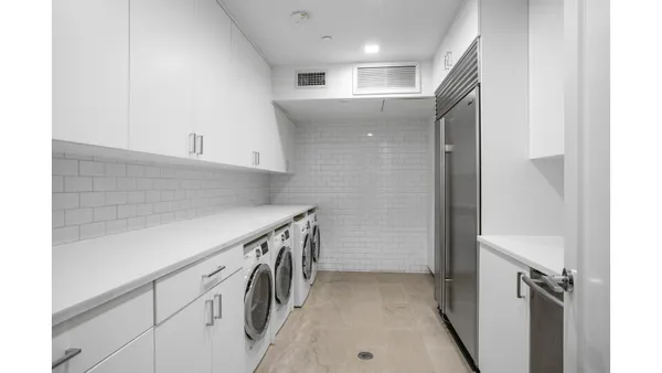 a living room with furniture and a glass door