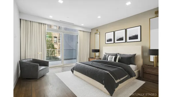 a very nice looking dining room with a large window and chandelier