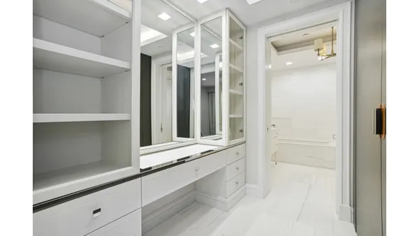 a bedroom with a large bed and a couch