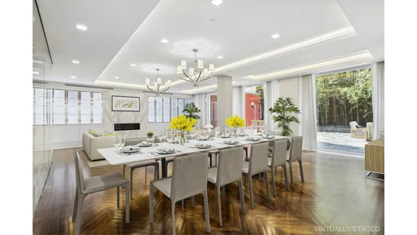 a living room with furniture kitchen and a large window