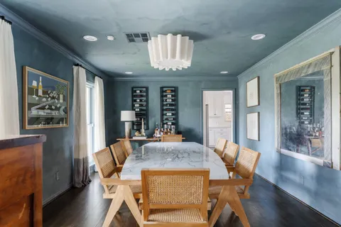 a view of a dining room with furniture wooden floor and chandelier