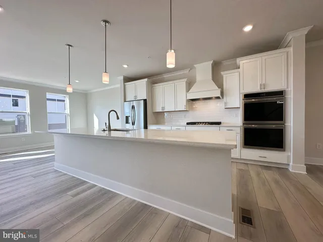 a view of kitchen with sink microwave and stove