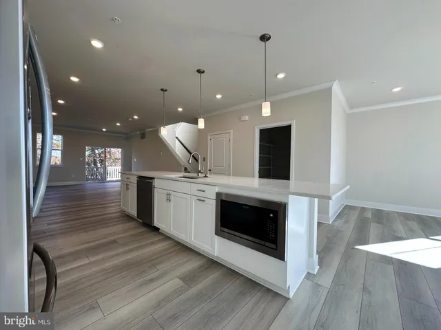 a kitchen with a sink stainless steel appliances and cabinets