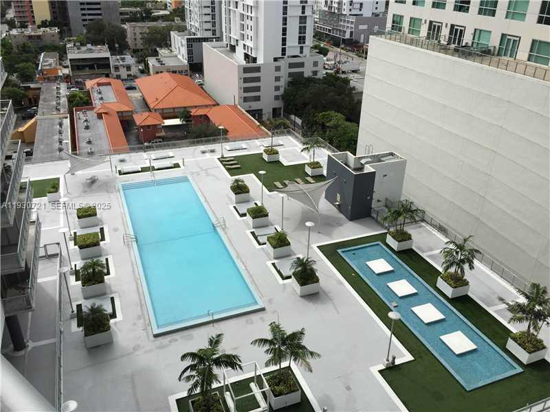 690 Southwest 1st Court, Unit 1727 Miami, FL 33130 - Photo 12 of 15 an aerial view of a pool patio kitchen and outdoor seating