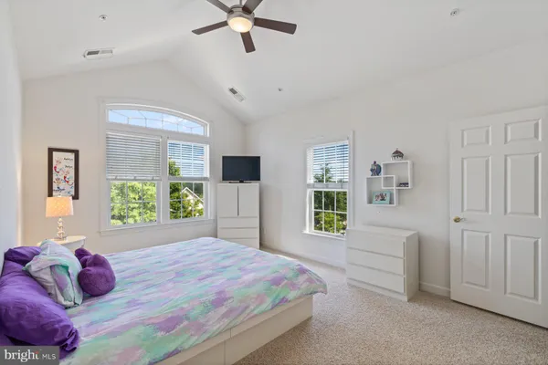 a bedroom with a bed and ceiling fan
