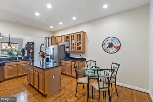 a view of a dining room with furniture a chandelier and wooden floor