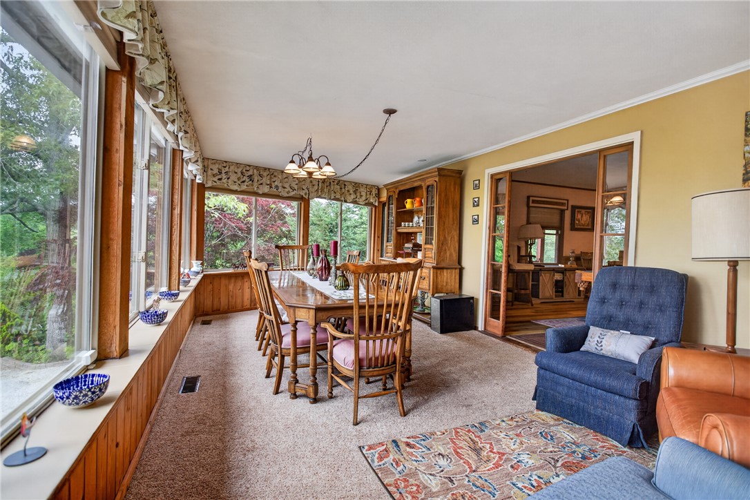 351 River Road Westminster, SC 29693 - Photo 12 of 50 A spacious sunroom/dining room offers tranquil views of the surrounding natural landscape, perfect for dining or relaxation.