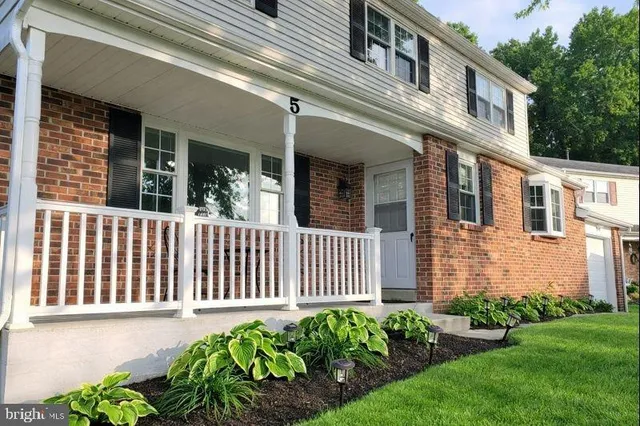 a view of a patio with a table and chairs and potted plants