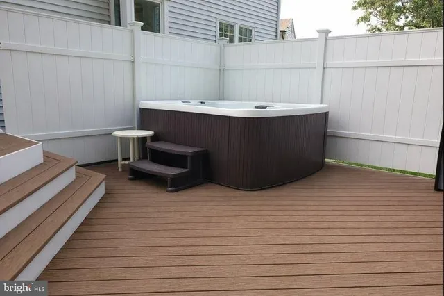 a small white sitting area with an umbrella