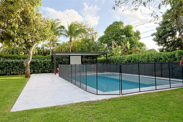 a view of a backyard with trampoline